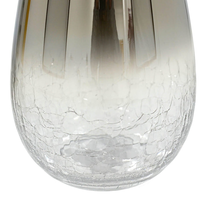 Close up of crackle glass base of a flower vase on a white background