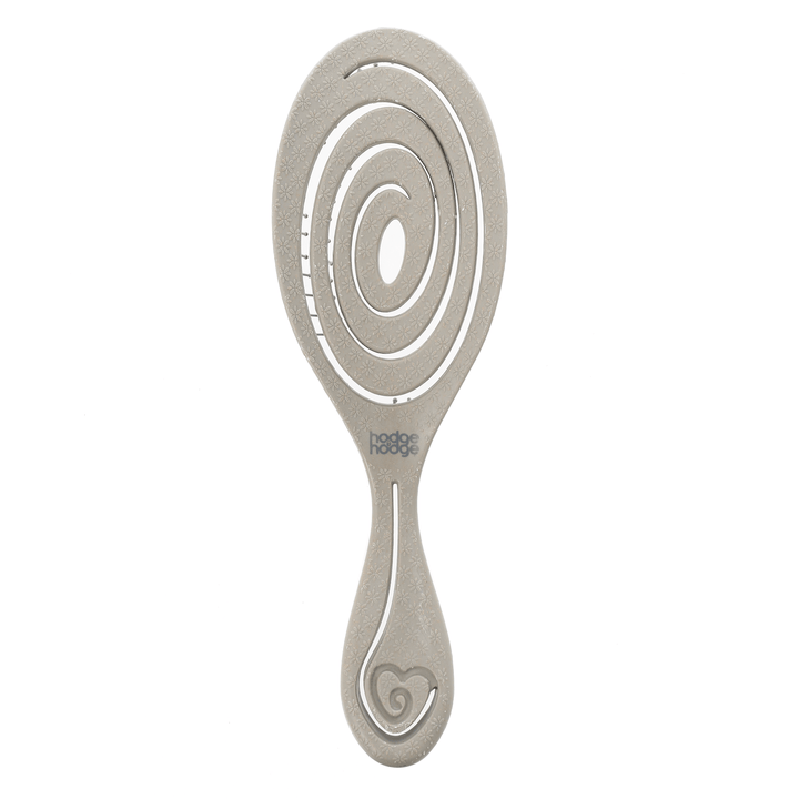 Grey paddle hairbrush with circular design on a white background