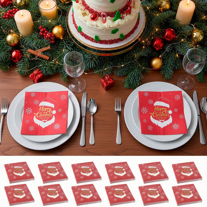 Christmas-themed table setting with a cake, candles, and red 'Merry Christmas' Santa napkins.