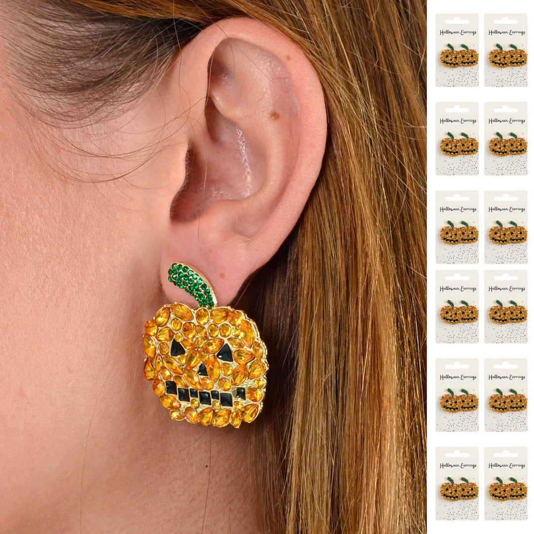 Pumpkin-shaped earring with rhinestones worn by a person with a close-up of the earring.