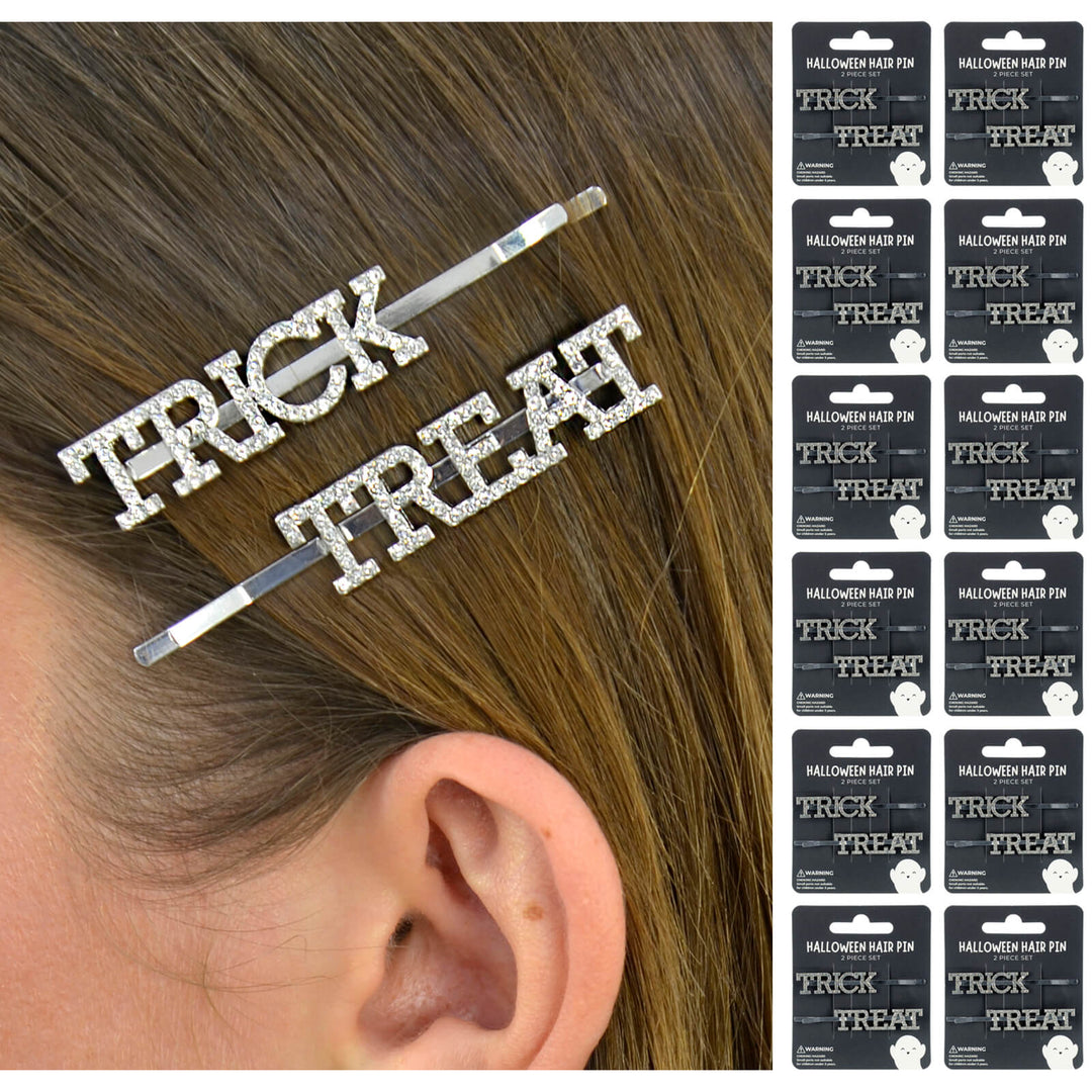 Silver 'TRICK OR TREAT' hair pins on a person's hair with packaging in the corner.