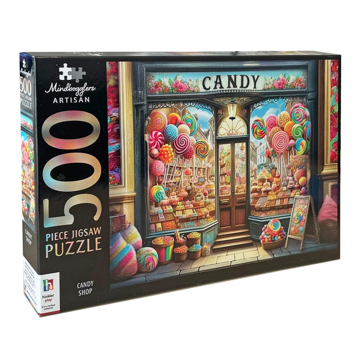 A 500-piece jigsaw puzzle box by Mindboggles Artisan, featuring a colorful illustration of a candy shop storefront with lollipops, sweets, and the words 'CANDY' above the door.