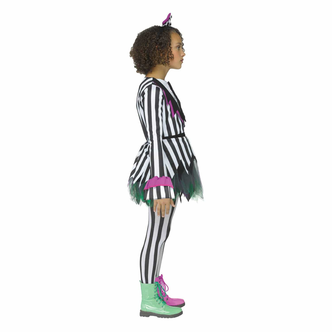 A child model shown in profile wearing a black and white striped costume with green and pink accents, black-and-white striped tights, green and pink lace-up boots, and hair bow, on a plain white background.