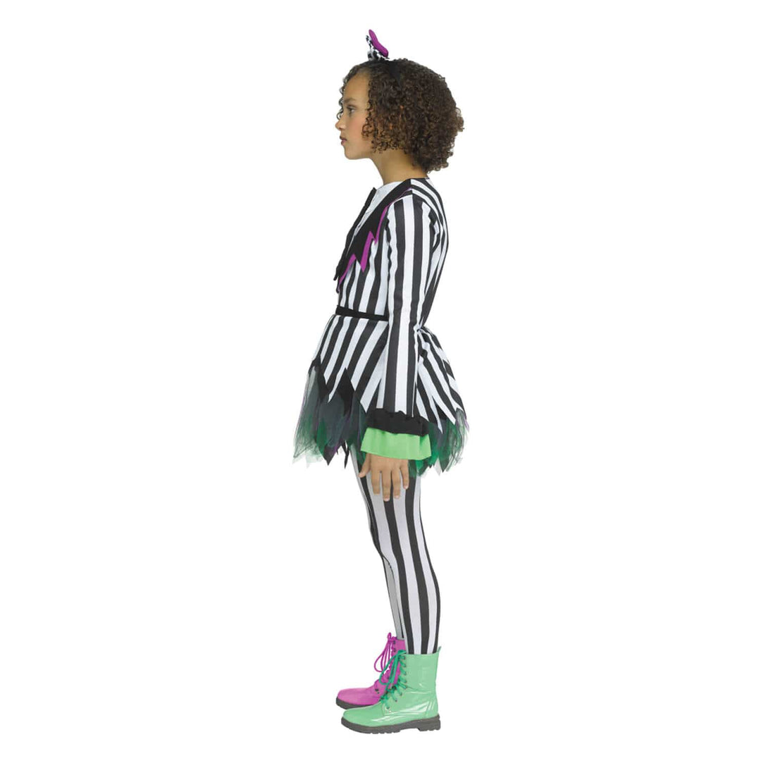 A child model shown in profile wearing a black and white striped costume with green and pink accents, black-and-white striped tights, green and pink lace-up boots, and hair bow, on a plain white background.