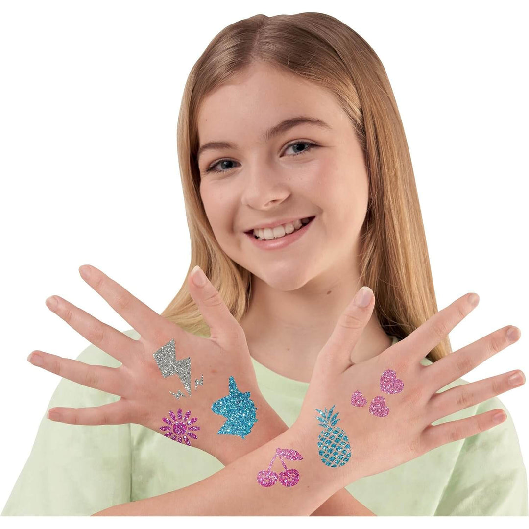 Girl showing glitter tattoos on her hands