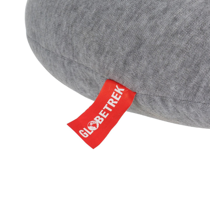 close up of red globetrek brand tab on side of grey coloured hooded neck travel pillow