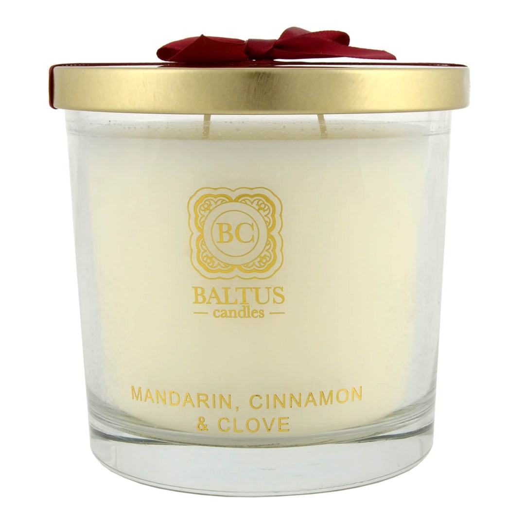 Baltus candles jar with gold lid and red bow on a white background