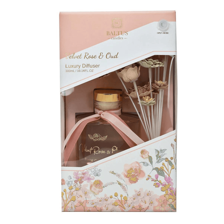 velvet rose & oud box packaging with pink and white faux flowers and reed diffuser scent inside