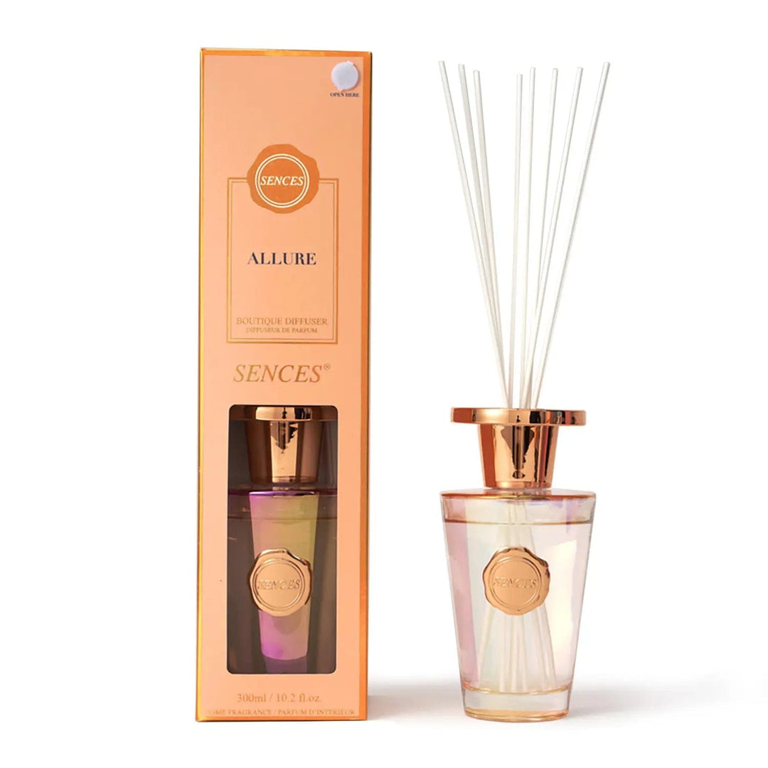 Allure scented diffuser in peach packaging with rose gold top bottle and white reeds