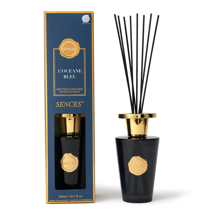 L'Oceane Bleu scented diffuser in dark blue with gold top bottle and black reeds