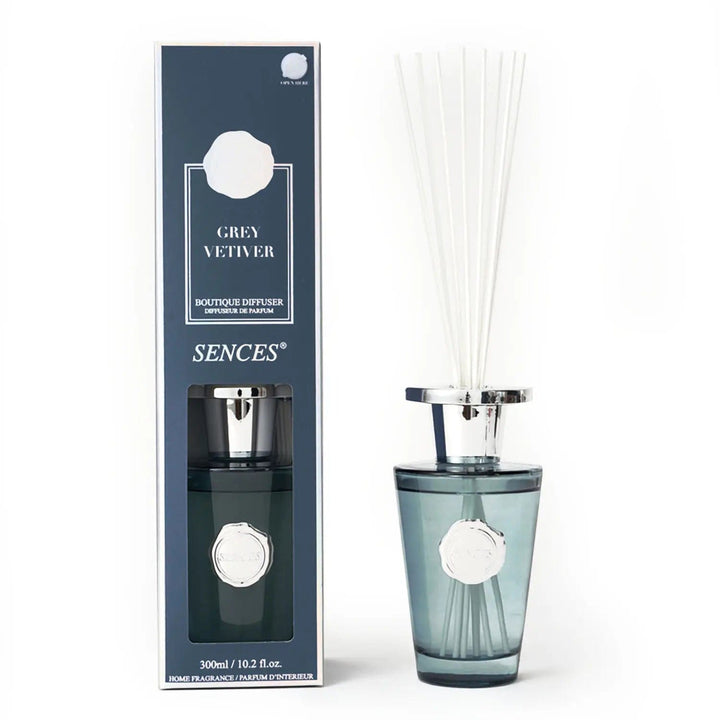 Grey Vetiver scented room diffuser in grey with silver top bottle and white reeds