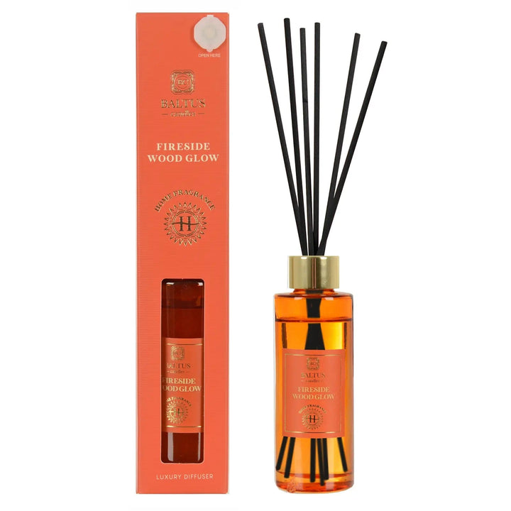 Fireside Wood Glow scented luxury diffuser with black reeds and orange coloured glass bottle