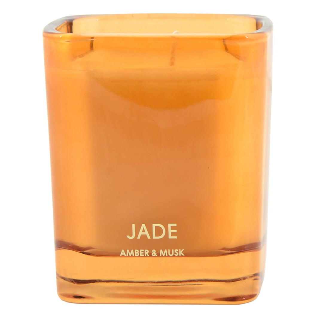 Side view of an orange glass candle holder