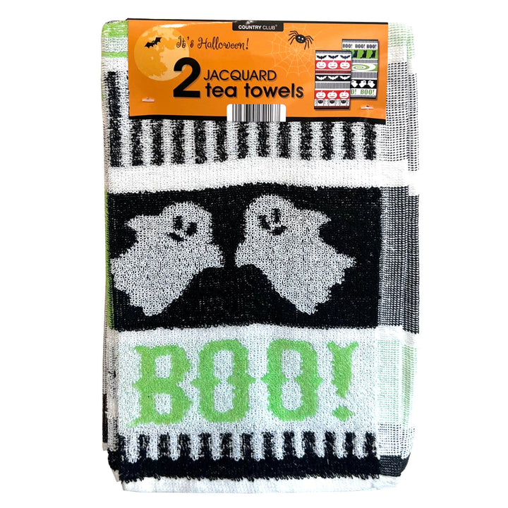 A packaged set of two Halloween-themed jacquard tea towels. The towels feature a black and white pattern with two smiling ghosts and the word &