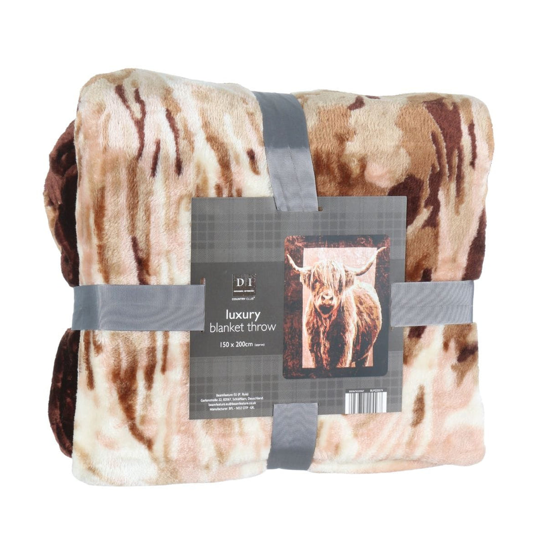 blanket throw folded and wrapped in grey ribbon with brand tab