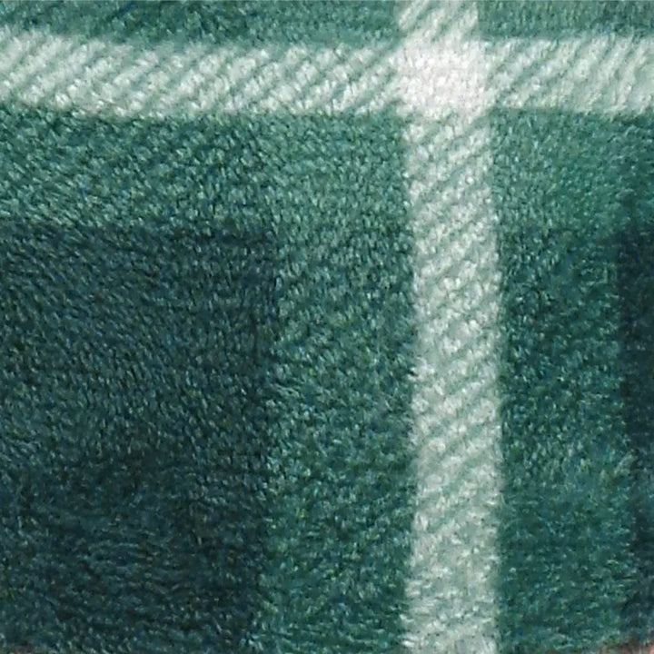 Close up detail of green and white tartan pattern blanket throw