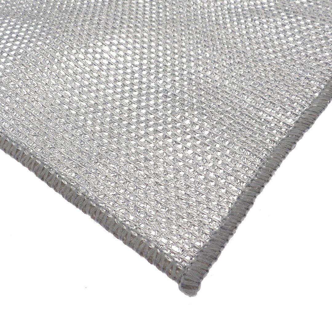 Close-up of a textured silver open weave cleaning cloth on a white background
