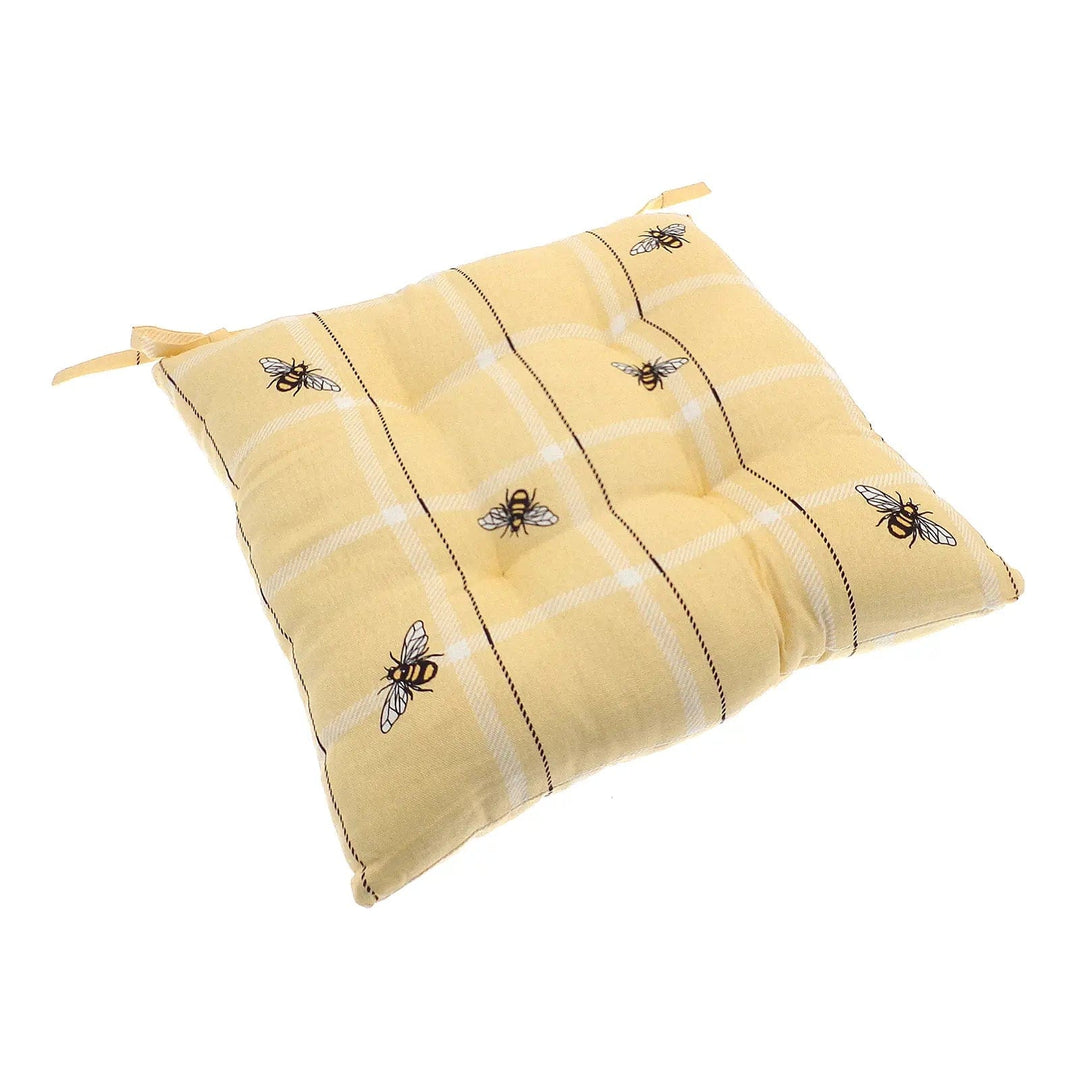 Yellow upholstered chair cushion in yellow with bumblebee pattern and checks