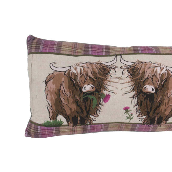 close up of draught excluder featuring highland cow with thistle in it&