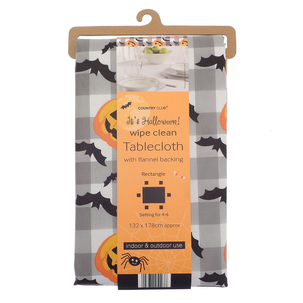 A packaged Country Club 'Sh's Halloween! wipe clean tablecloth with flannel backing, featuring a gray buffalo plaid pattern with black bats and orange pumpkins, hanging on a wooden hanger.