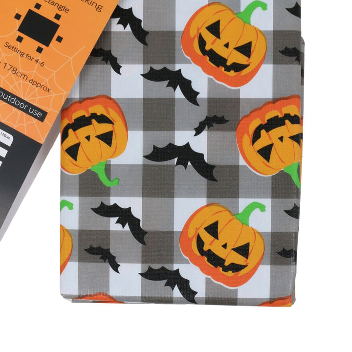 Halloween-themed fabric with a gray and white buffalo plaid pattern, decorated with orange jack-o&