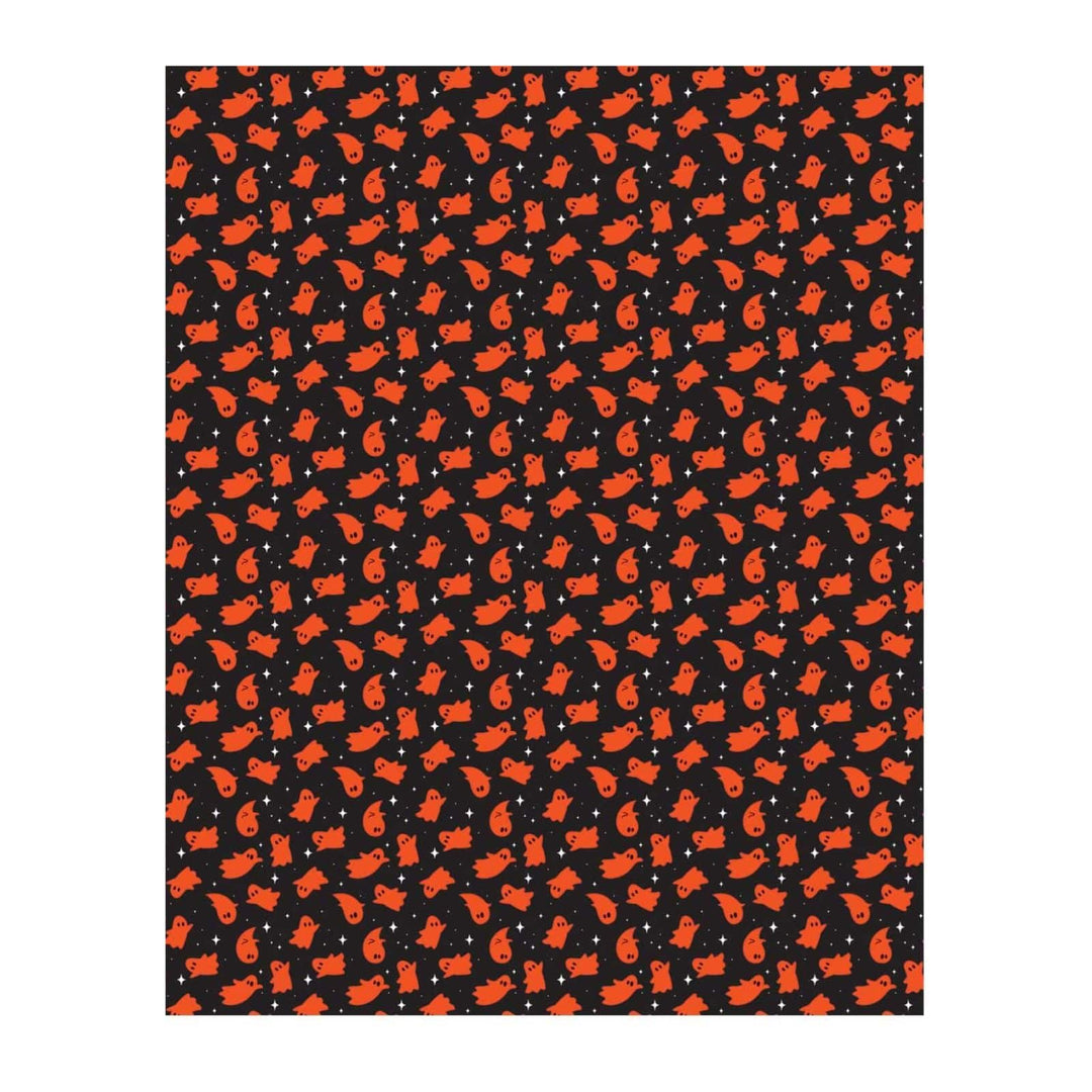 A rectangular blanket featuring a repeating pattern of orange cartoon ghosts on a black background, shown against a white backdrop.