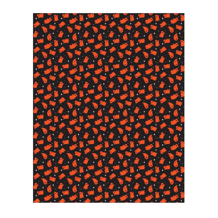 A rectangular blanket featuring a repeating pattern of orange cartoon ghosts on a black background, shown against a white backdrop.