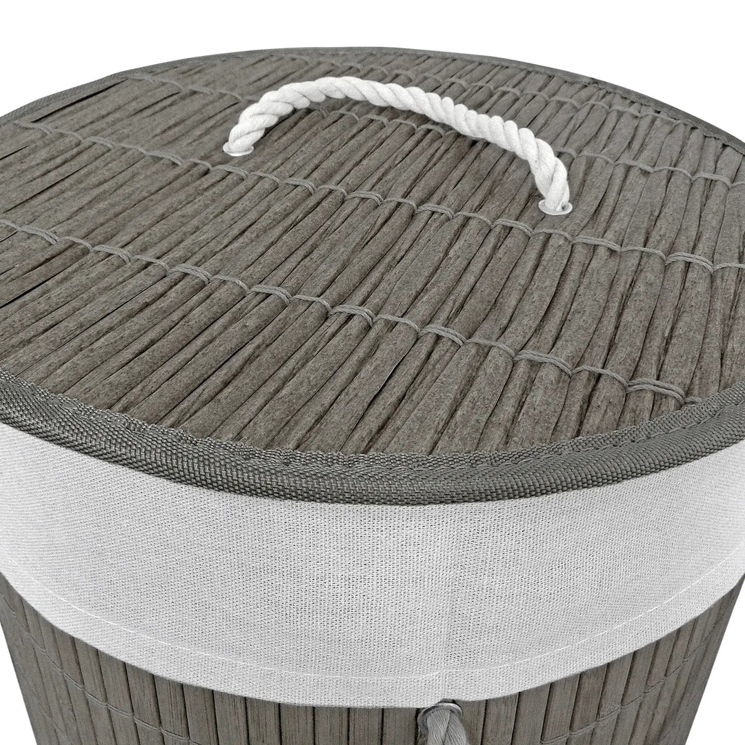 Details of rattan effect lid with white rope handle on a grey bamboo laundry basket on 