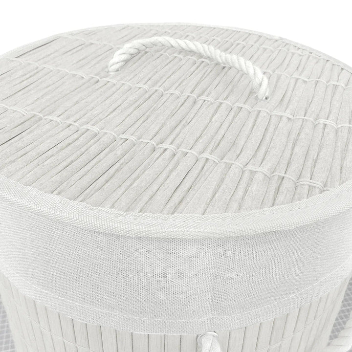 Details of rattan effect lid with white rope handle on a white bamboo laundry basket on 