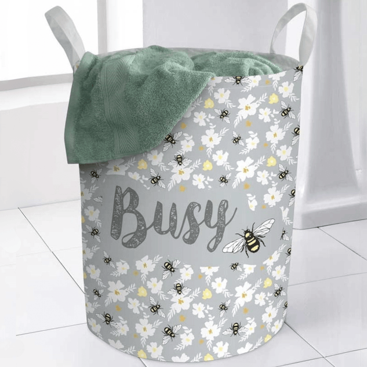 grey floral pattern laundry bag with busy slogan and bee illustration to the side. green towel inside