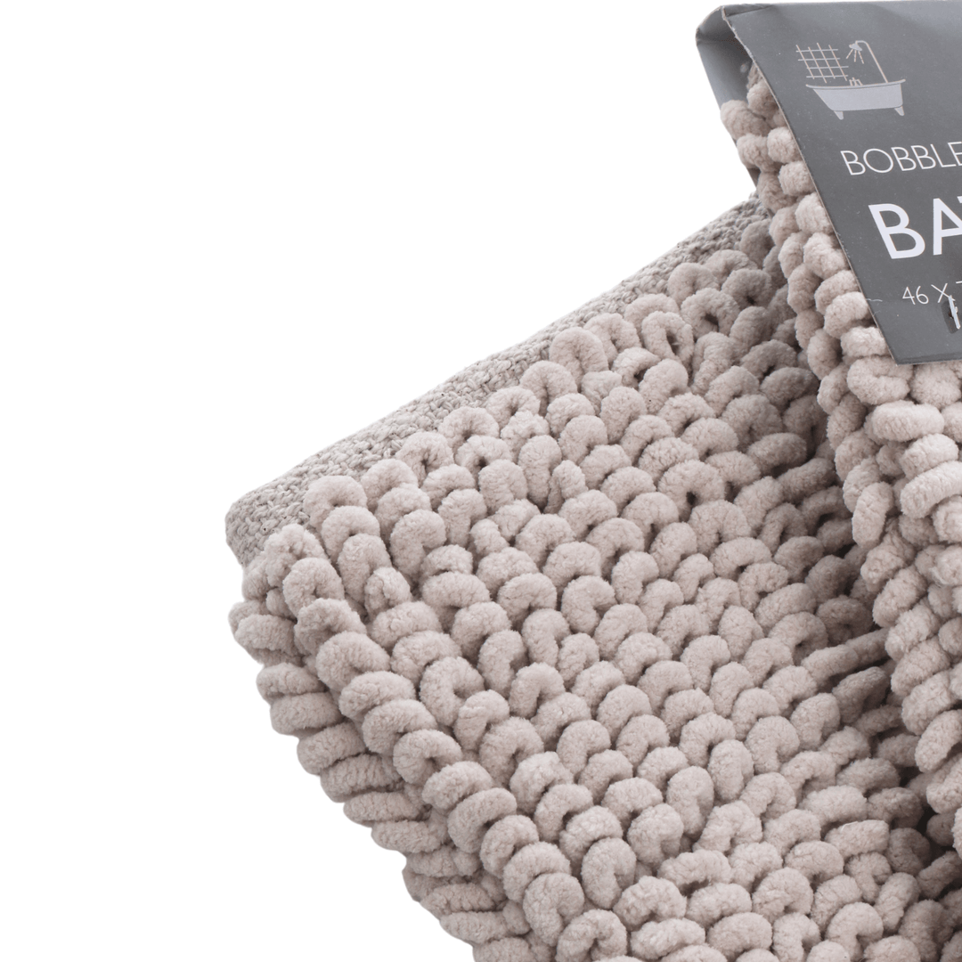 close up of bobble detail on stone coloured bath mat