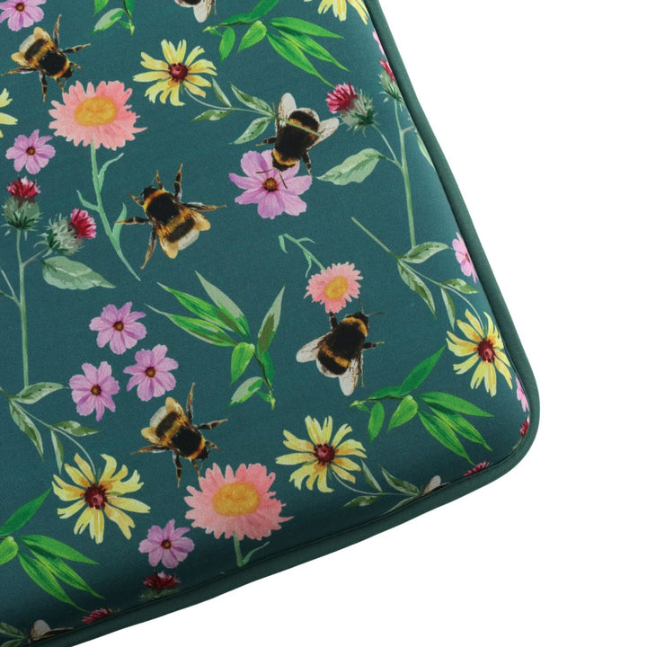 close up of kneeling mat with flower and bee pattern in green on white background