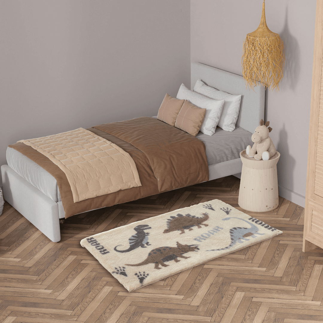 dinosaur design bedroom rug featuring roar slogan in bedroom beside bed
