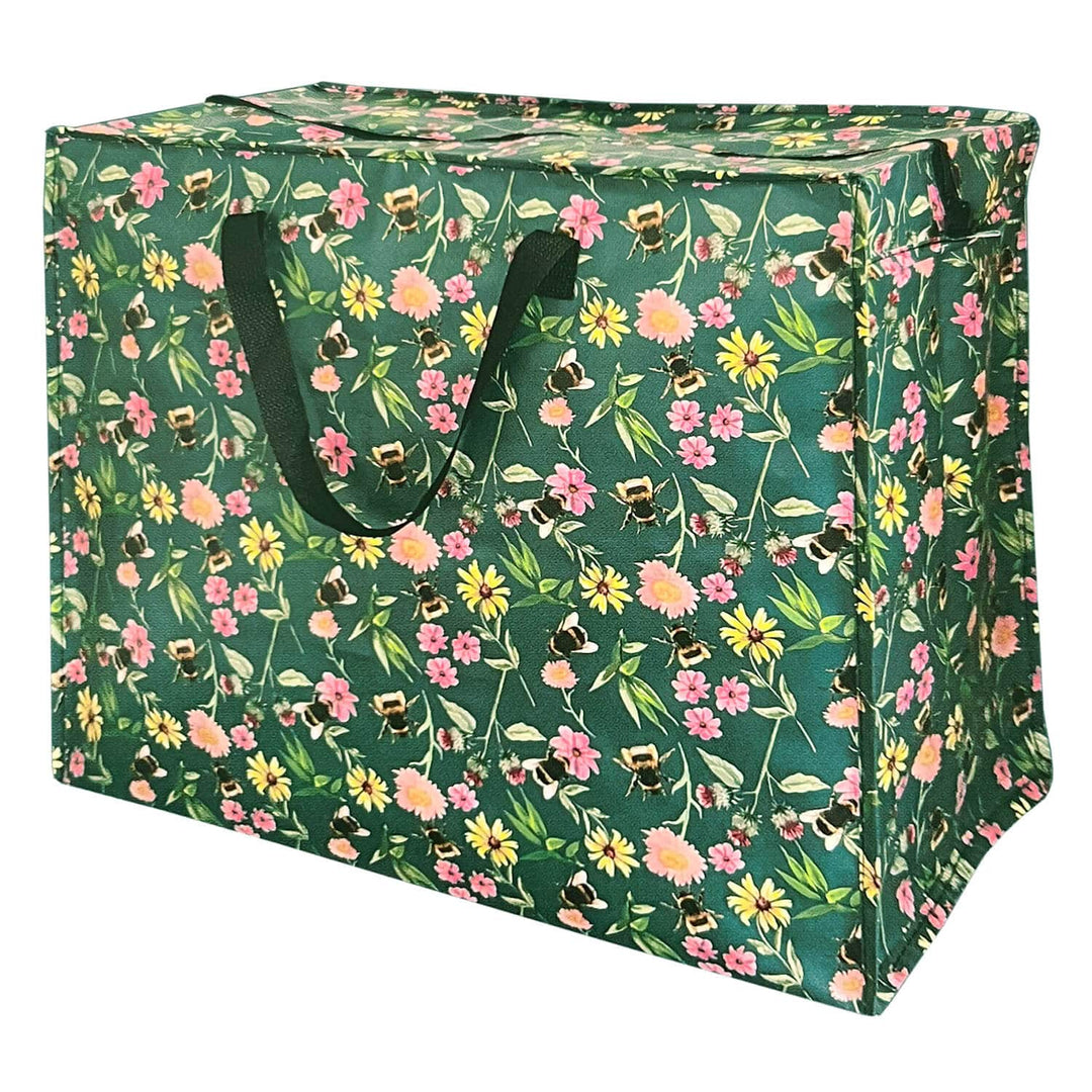 A green fabric storage bin with a dense floral and bee print, featuring dark green handles, shown on a plain white background.