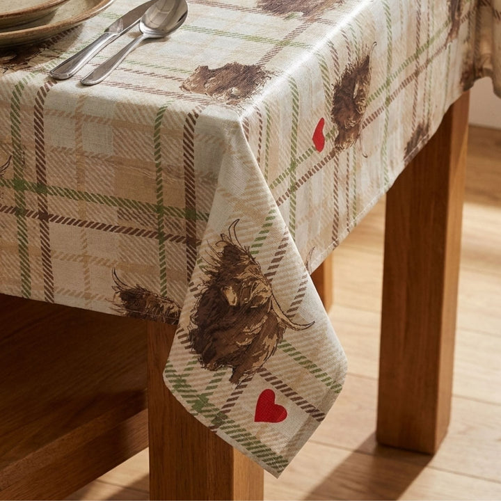 Tablecloth with highland cow animal and heart design on a wooden table
