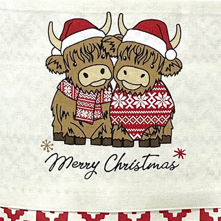 Pair of Highland cows and Merry Christmas text on a festive apron pocket