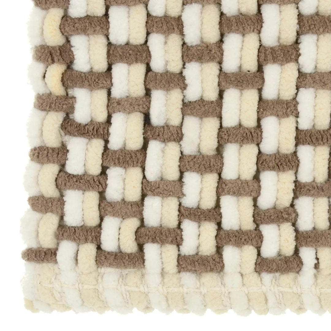 Close up of chunky woven fibres on a bath mat in natural colours