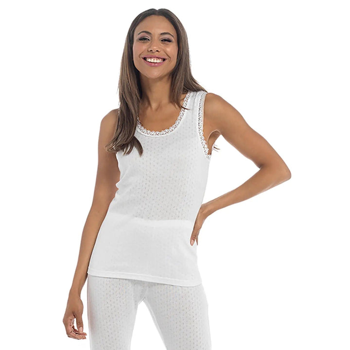 Lady wearing a thermal sleeveless vest top in white for winter base layer clothing