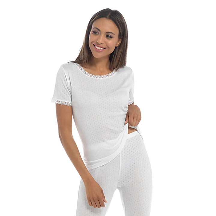 Lady wearing a short sleeve thermal top in white for winter base layer clothing