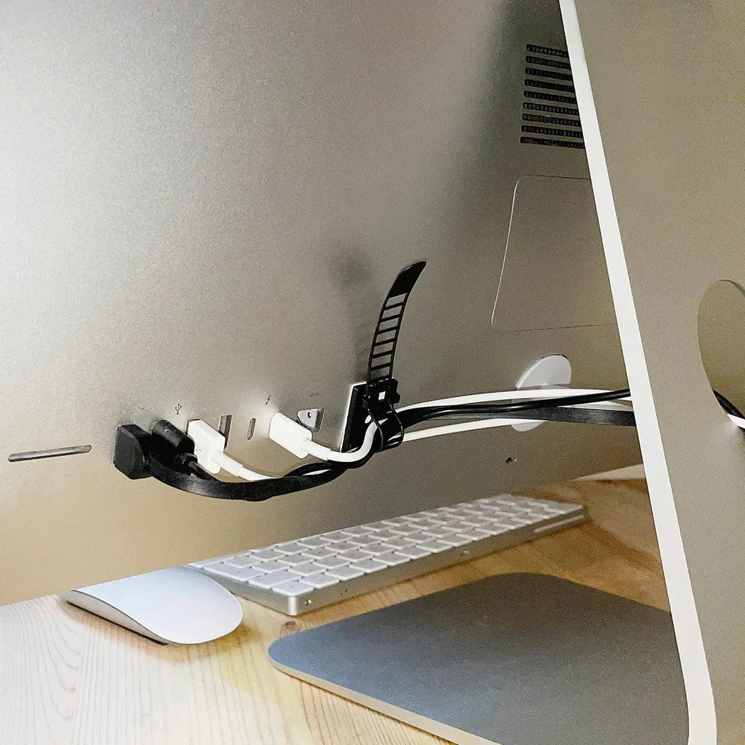 Cable tie attached to the back of a desktop Mac holding computer cables