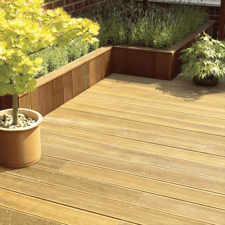 Wooden deck with potted plants and garden bed with lavender inside