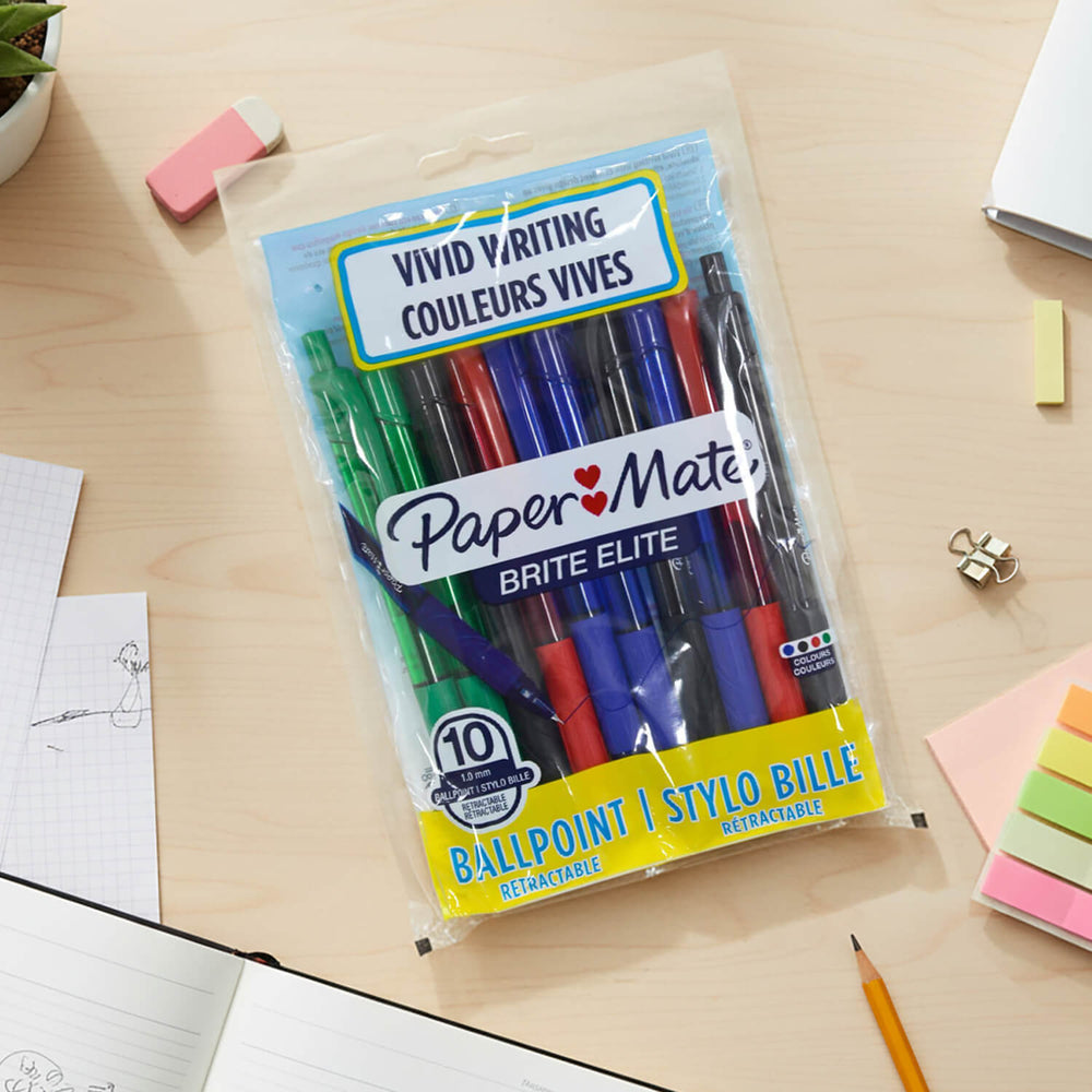 Pack of Paper Mate Brite Elite ballpoint pens on a desk with stationery items.