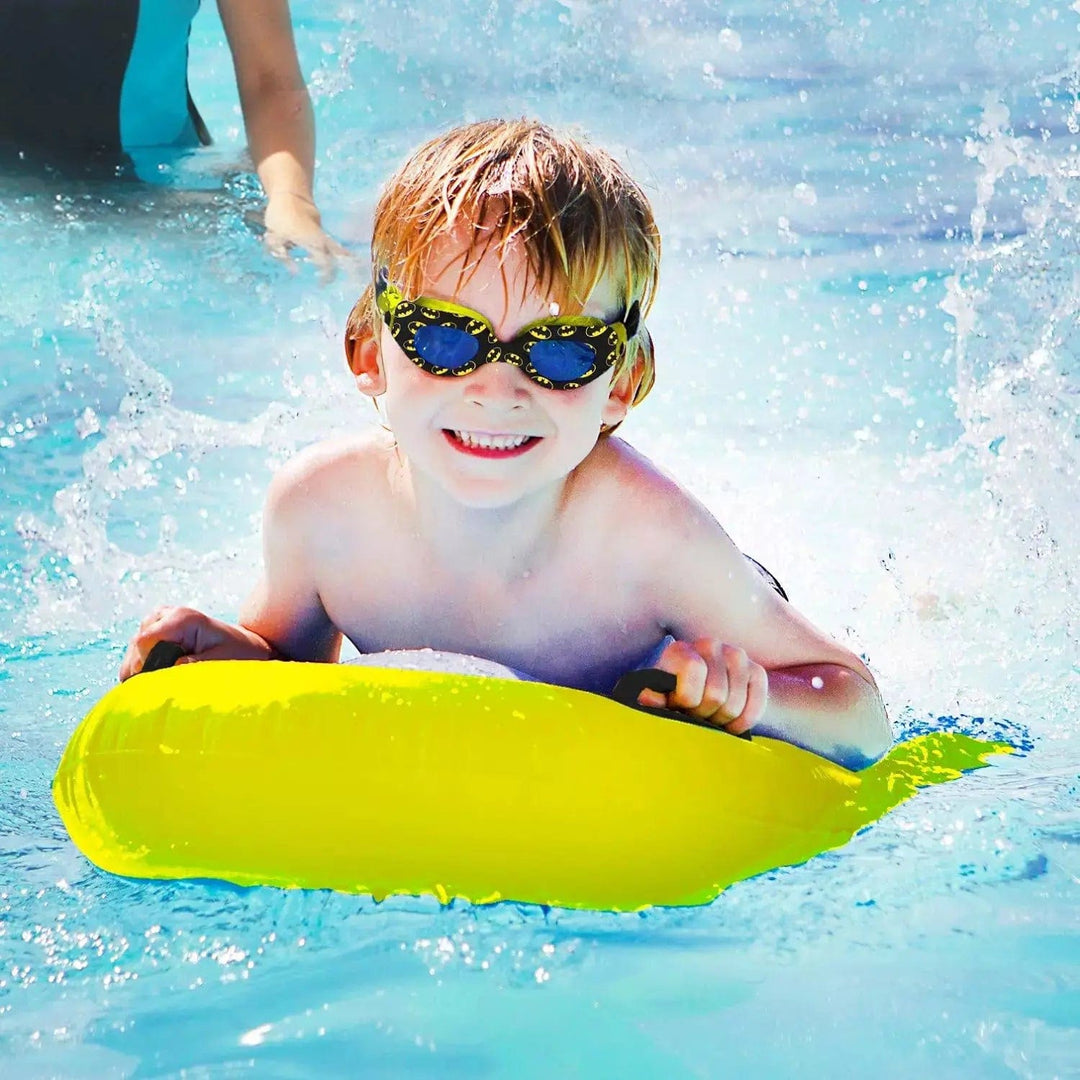 Boy on a swimming float wearing batman logo goggles