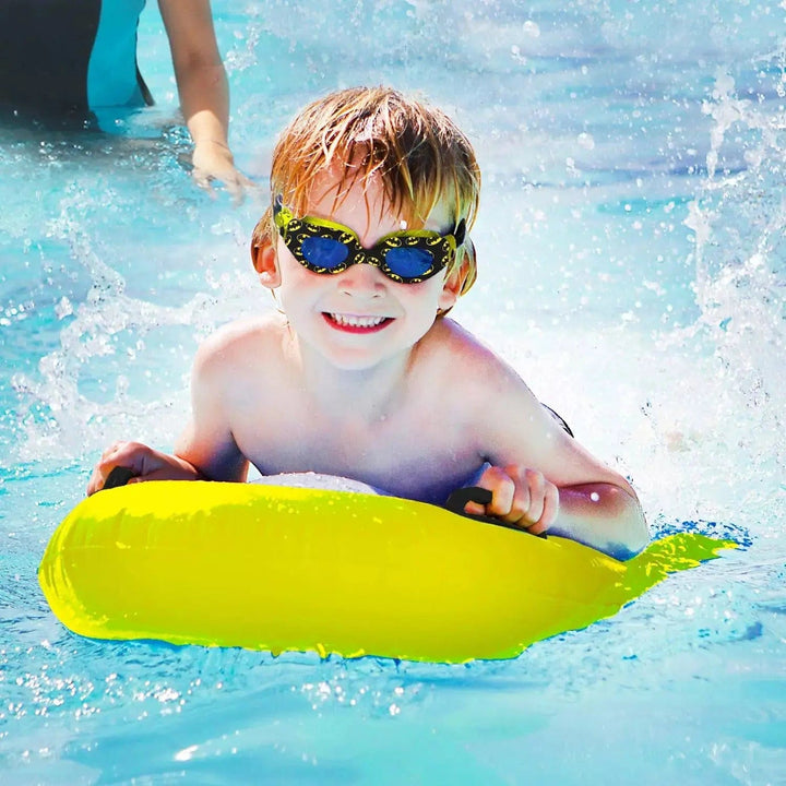 Boy on a swimming float wearing batman logo goggles