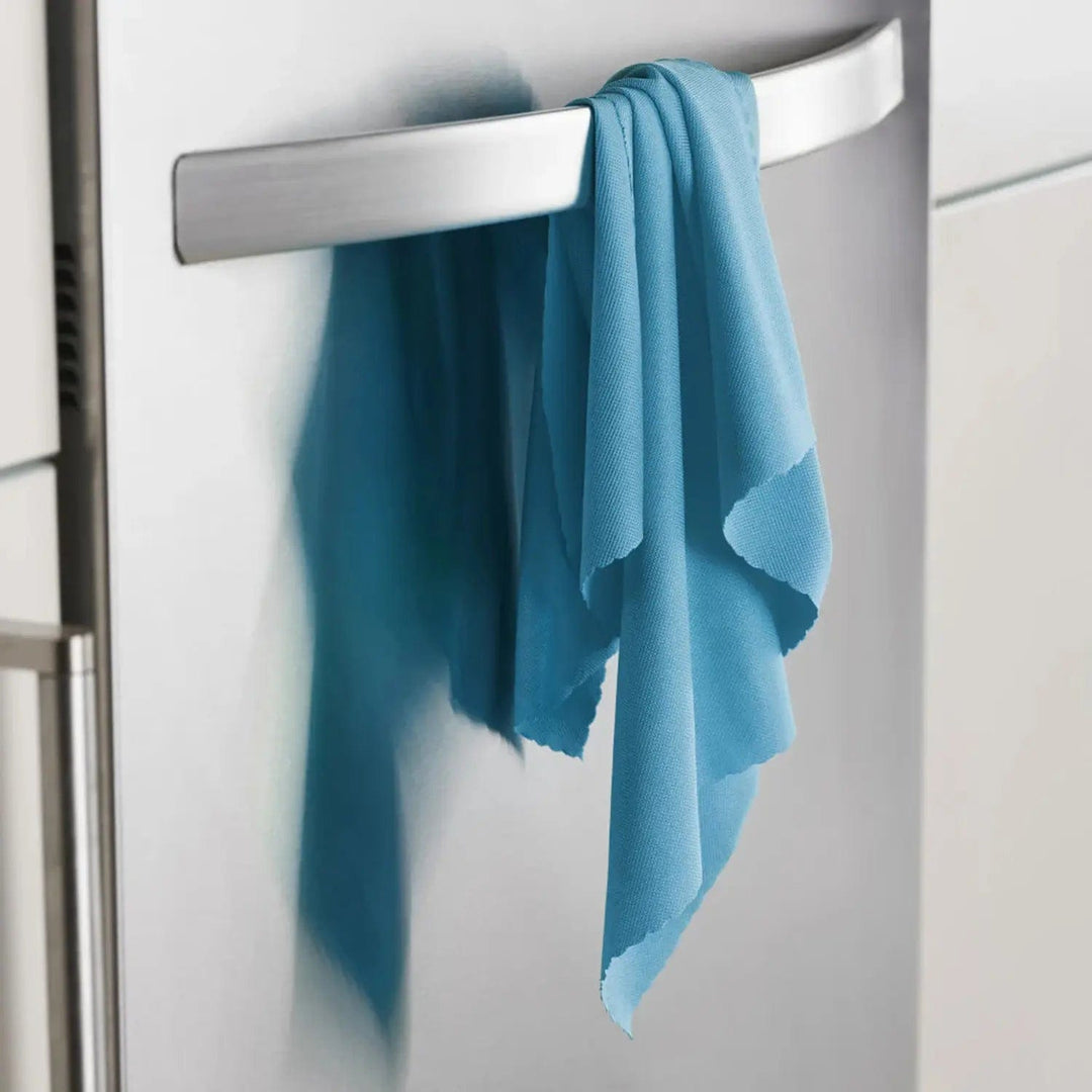 Blue cloth hanging over a handle of an appliance in the kitchen