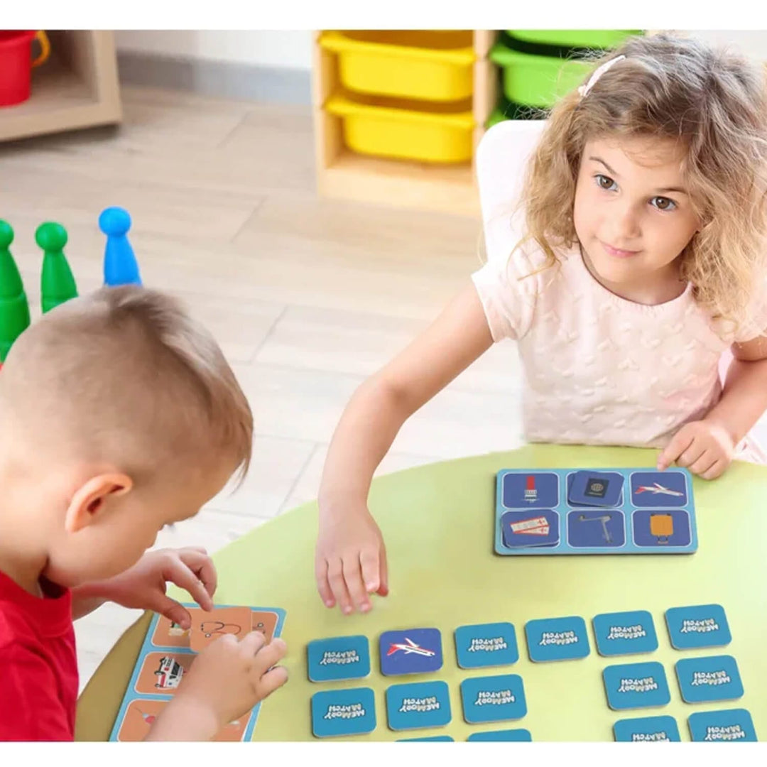2 children playing a memory match game with tiles and boards