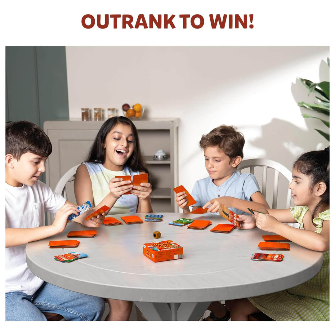 4 children at a table playing Rank Up card game like trumps