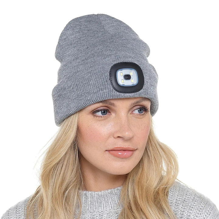 Lady wearing a grey beanie hat with LED light on the front