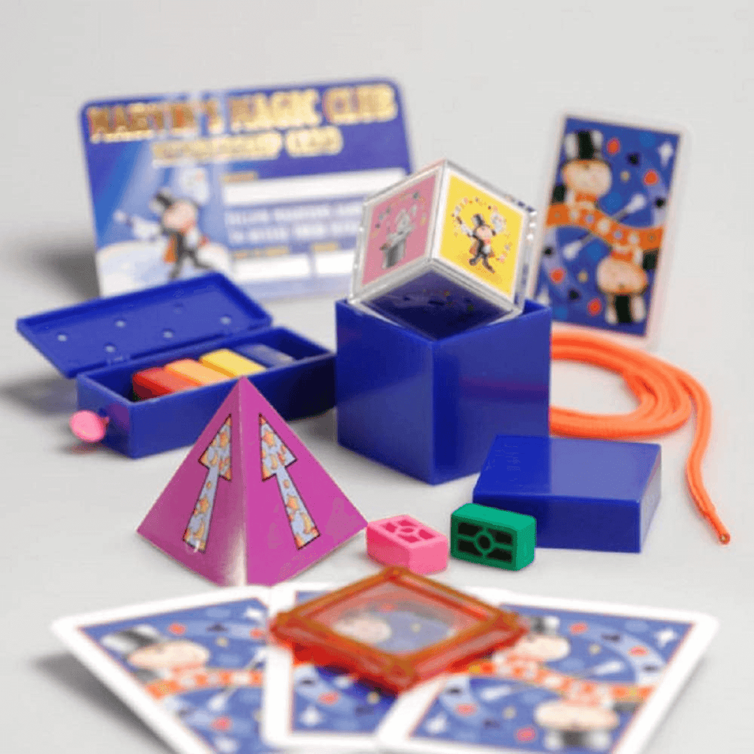 detail shot of magic tricks included in series 3 of 3 with colour blocks, playing cards, graphic cube, orange string and more