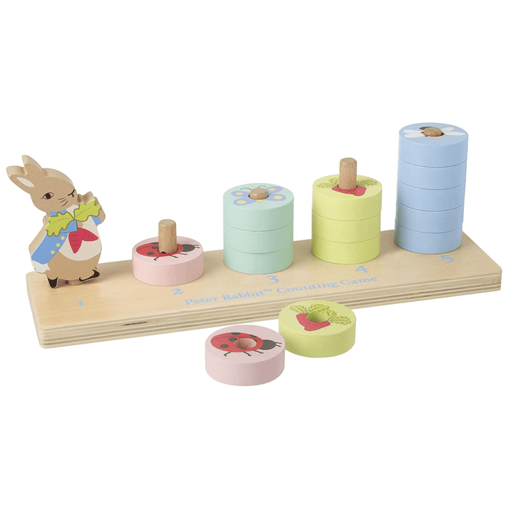 peter rabbit wooden counting game with pastel coloured (pink, greens and blue discs) on wooden board with peter rabbit character and blue coloured writing